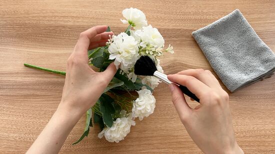 brushing the artificial flowers by gardengreen